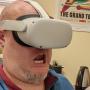 Man wearing a VR headset, mouth agape as if shocked or surprised.