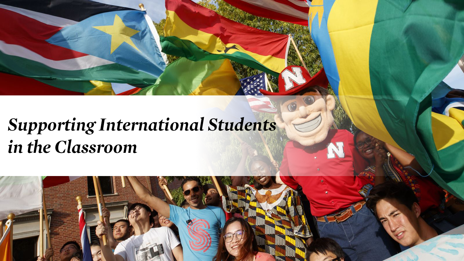 Herbie Husker and international students flying flags of different countries