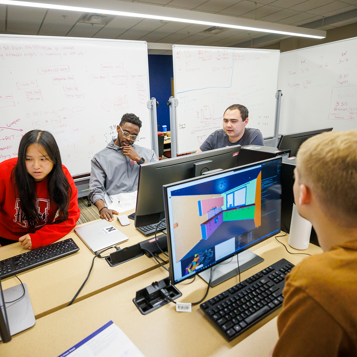 Students with computers and whiteboards