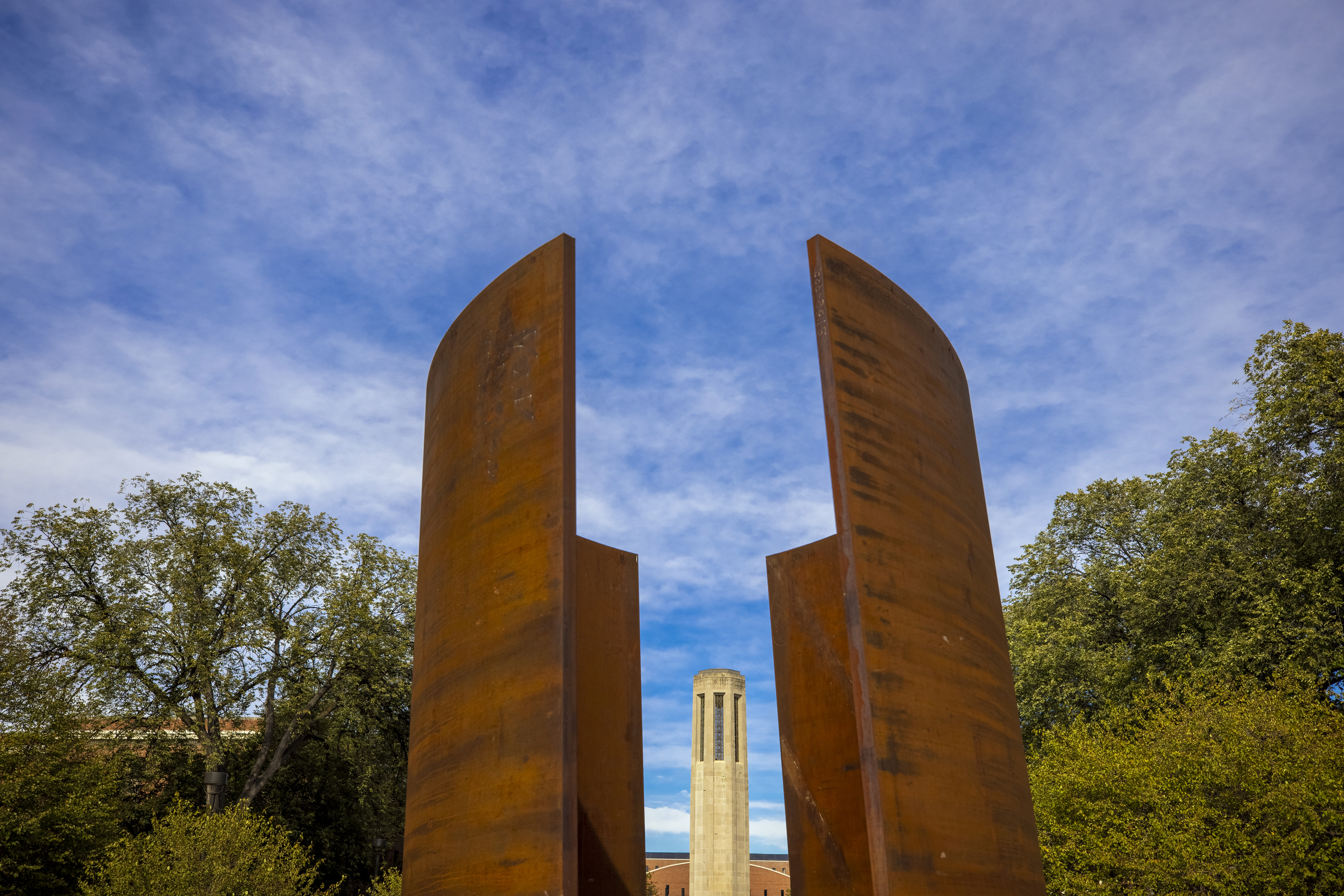 The Mueller Bell Tower is framed by the Greenpoint sculpture. City Campus. October 28, 2020. Photo by Craig Chandler / University Communication.