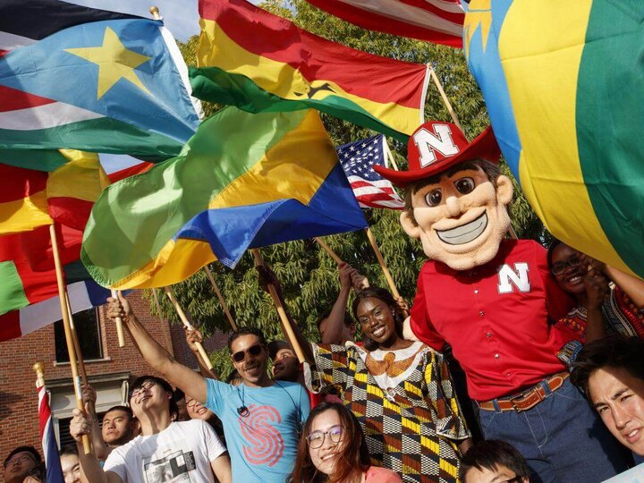 Herbie Husker with students and country flags